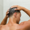 Model washing hair with Grow Shampoo