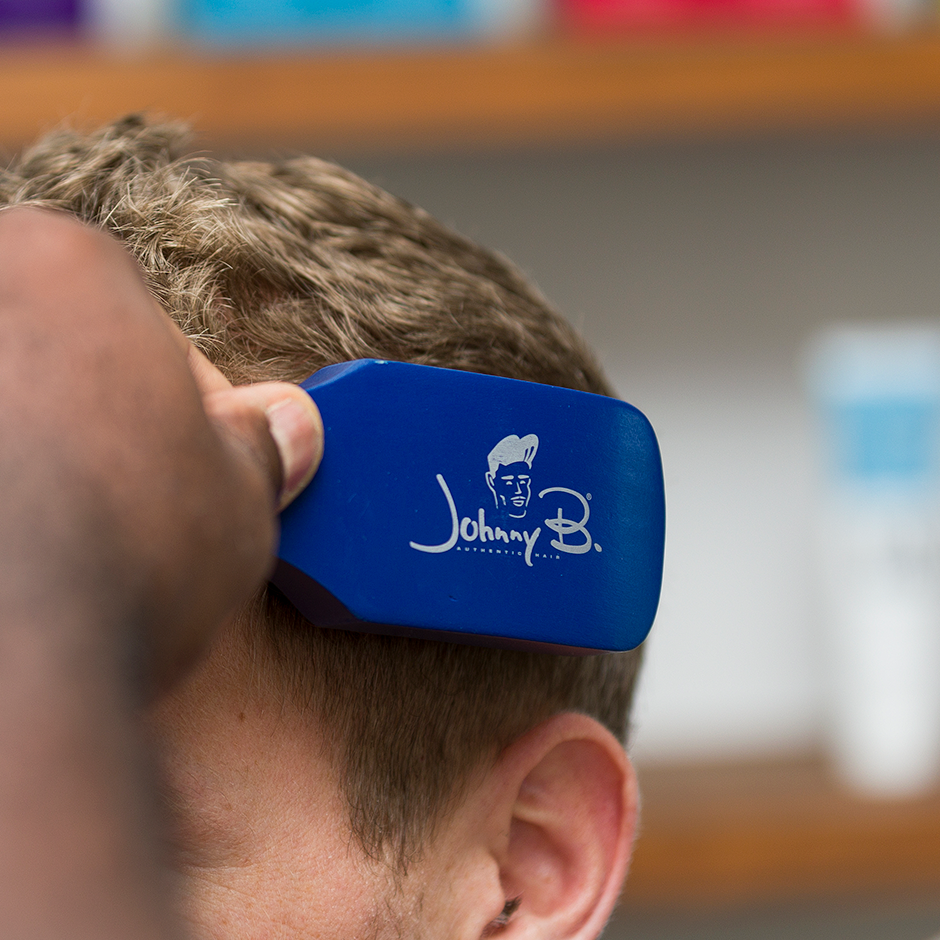 Barber using Barber Brush to brush hair