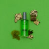 Wood and moss laid around a NOON After Shave 3.3oz bottle