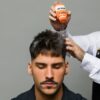 Barber using Hold Up on man's hair