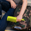 Kid putting Detangle Comb into his backpack