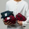 Man holding 3 Dopp Bags in arms