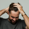 Man using Utility Cream to style hair