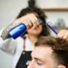 Barber using Spray Bottle on hair