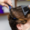 Blowdrying hair with boom brush